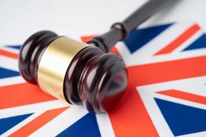 Gavel for judge lawyer on United Kingdom flag, finance concept. photo