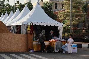 Kudus, December 2022. Photo portrait of the Kudus Expo Micro, Small and Medium Enterprises, with various kinds of clothing, food and drinks. located in the Kudus square crowded with sellers  visitors.