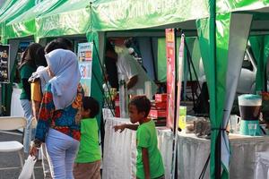 Kudus, December 2022. Photo portrait of the Kudus Expo Micro, Small and Medium Enterprises, with various kinds of clothing, food and drinks. located in the Kudus square crowded with sellers  visitors.