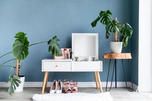 Stylish room interior with elegant dressing table and plants photo