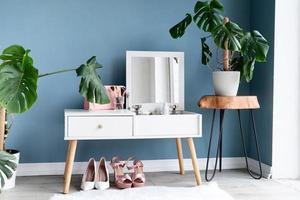 Stylish room interior with elegant dressing table and plants photo