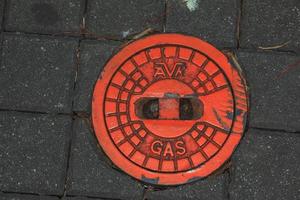 tapa de alcantarilla del sistema de gasoductos. una escotilla metálica masiva para el acceso a las comunicaciones de la ciudad en el pavimento. foto