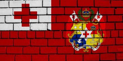 Flag and coat of arms of the Kingdom of Tonga on a textured background. Concept collage. photo