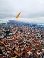 Istanbul, Turkey - 10.17.2021 A Pegasus airline plane comes in for landing in Istanbul among clouds at altitude close up of its wing. photo