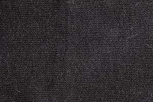 Black texture wool close-up, woven cloth, knitted fabric. photo