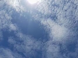 Beautiful white clouds on deep blue sky background. Large bright soft fluffy clouds are cover the entire blue sky. photo