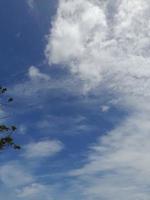 Beautiful white clouds on deep blue sky background. Large bright soft fluffy clouds are cover the entire blue sky. photo