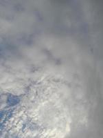 Beautiful white clouds on deep blue sky background. Large bright soft fluffy clouds are cover the entire blue sky. photo