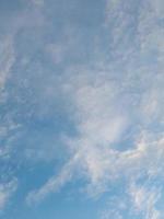 Beautiful white clouds on deep blue sky background. Large bright soft fluffy clouds are cover the entire blue sky. photo