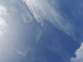 Beautiful white clouds on deep blue sky background. Large bright soft fluffy clouds are cover the entire blue sky. photo