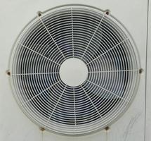 An old outdoor AC fan with white color and good lighting photo