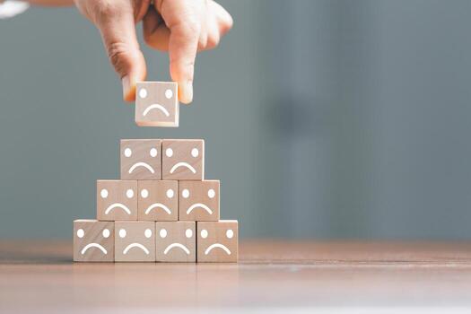 Rating feedback scale on wood cube with copy space. Service rating, dissatisfied with satisfaction concept, Bad review, bad service dislike bad quality, low rating, negative social media not good. photo