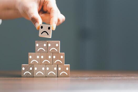 Rating feedback scale on wood cube with copy space. Service rating, dissatisfied with satisfaction concept, Bad review, bad service dislike bad quality, low rating, negative social media not good. photo