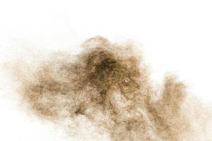 marrón partículas chapoteo en blanco antecedentes. marrón polvo salpicar. foto