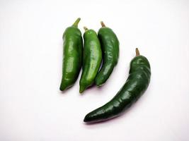 fresh green chilies isolated in white background photo