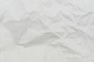 Wrinkled or crumpled white stencil paper or tissue after use in toilet or restroom with large copy space used for background texture in decorative art work photo