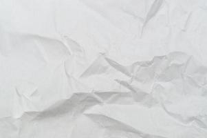 Wrinkled or crumpled white stencil paper or tissue after use in toilet or restroom with large copy space used for background texture in decorative art work photo
