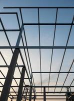 The unfinished steel framework of the modern house roof. photo