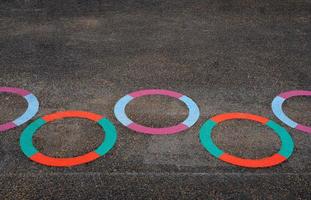 Multicolour Circle on floor in School playground.Bright colored paint on pavement at public Playground, Ourdoor activity for Kids,Learn and Play for Kindergarten school photo