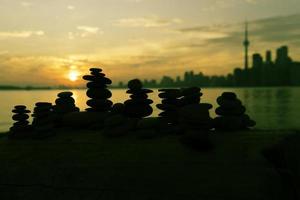 A stack of rocks on Centre Island with a view of Toronto in the backdrop. photo