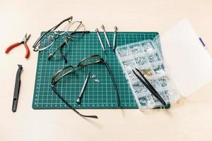 kit for repairing eyeglasses on wooden table photo