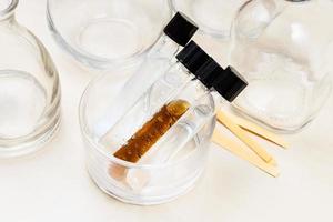 test tubes, bottles and indicator papers on desk photo