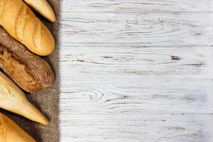 Homemade baguettes on wooden table. close up photo