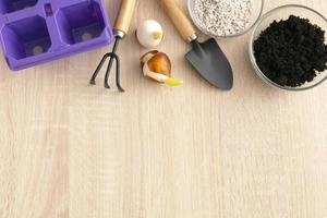 Gardening tools and flowers pots on wooden table. Flat lay gardening or planting concept. photo