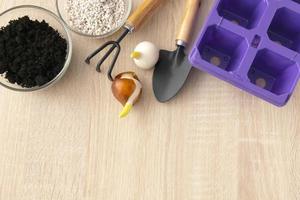 Gardening tools and flowers pots on wooden table. Flat lay gardening or planting concept. photo