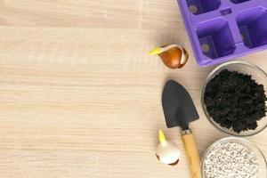 Gardening tools and flowers pots on wooden table. Flat lay gardening or planting concept. photo