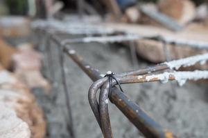 selective focus on the wire that binds the iron round bar for building in construction site, soft focus photo
