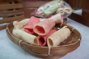 selective focus on colorful crackers on a bamboo plate, in Indonesian it is called kerupuk pelompong or krupuk pipa , soft focus photo