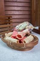 selective focus on colorful crackers on a bamboo plate, in Indonesian it is called kerupuk pelompong or krupuk pipa , soft focus photo