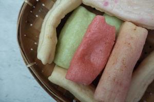 selective focus on colorful crackers on a bamboo plate, in Indonesian it is called kerupuk pelompong or krupuk pipa , soft focus photo