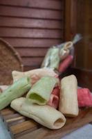selective focus on colorful crackers on a tray wood, in Indonesian it is called kerupuk pelompong or krupuk pipa, soft focus photo