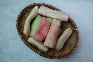 selective focus on colorful crackers on a bamboo plate, in Indonesian it is called kerupuk pelompong or krupuk pipa , soft focus photo