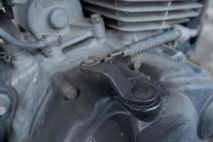 selective focus to old and dirty clutch sling of motorcycle engine, soft focus photo