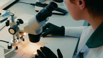 A research scientist examines microbiological samples for the presence of bacteria under a microscope. Working with a microscope close-up. video