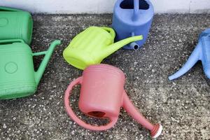 Colored plastic watering cans photo