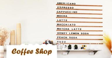 White coffee machine on counter with coffee menu on wooden shelf background in coffee shop photo