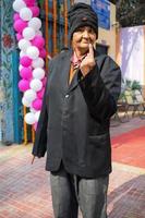 New Delhi, India - December 04 2022 - Unidentified people showing their ink-marked fingers after casting votes in front of polling booth of east Delhi area for MCD local body Elections 2022 photo