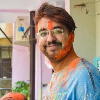 Indian family people playing colours on Holi festival, holding different colours, Holi festival celebrations in Delhi, India photo