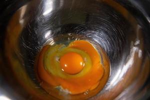 Egg yolk in mixing bowl photo