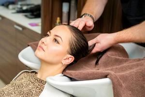 Hairdresser wipes the hair with towel photo