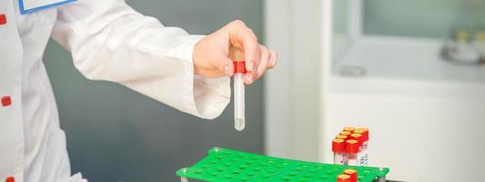 Nurse takes empty blood test tube photo