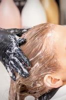 Young woman receiving hair wash photo