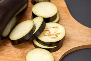 Eggplant on wooden cutting board photo