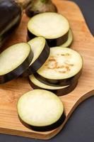 Eggplant on wooden cutting board photo