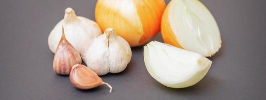 Unpeeled raw garlic and onion photo