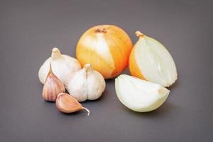 Unpeeled raw garlic and onion photo